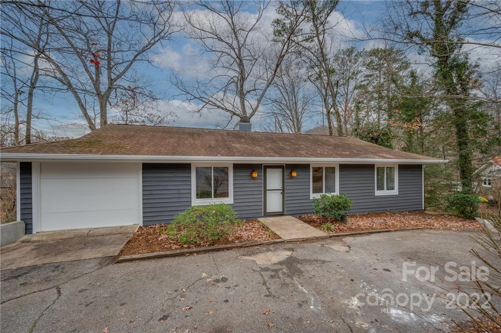 241 Hidden Hill Road Tryon, NC 28782 - Photo 2 of 39 a front view of a house with garden