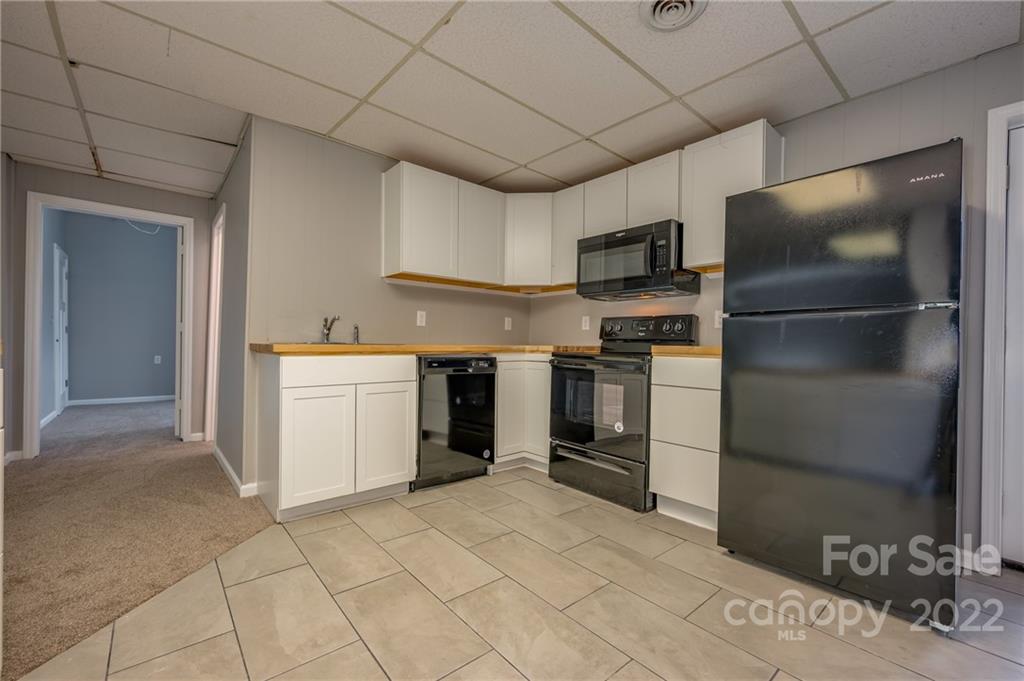 241 Hidden Hill Road Tryon, NC 28782 - Photo 25 of 39 a kitchen with a refrigerator stove and microwave