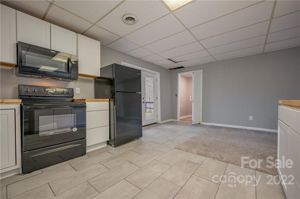 241 Hidden Hill Road Tryon, NC 28782 - Photo 26 of 39 a kitchen with stainless steel appliances granite countertop a refrigerator and a stove top oven