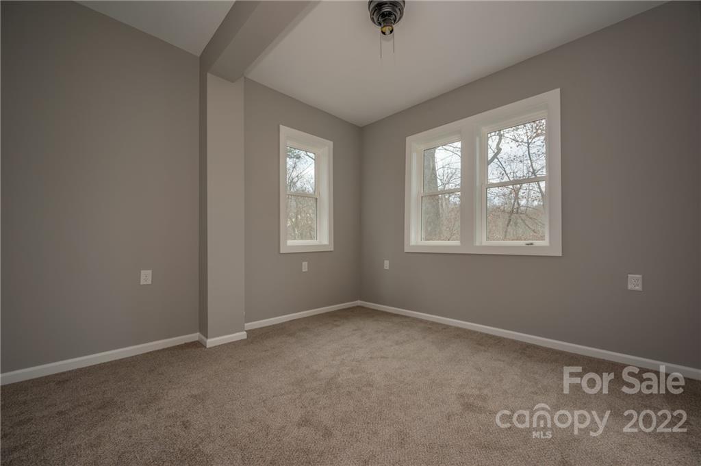 241 Hidden Hill Road Tryon, NC 28782 - Photo 29 of 39 an empty room with windows and closet