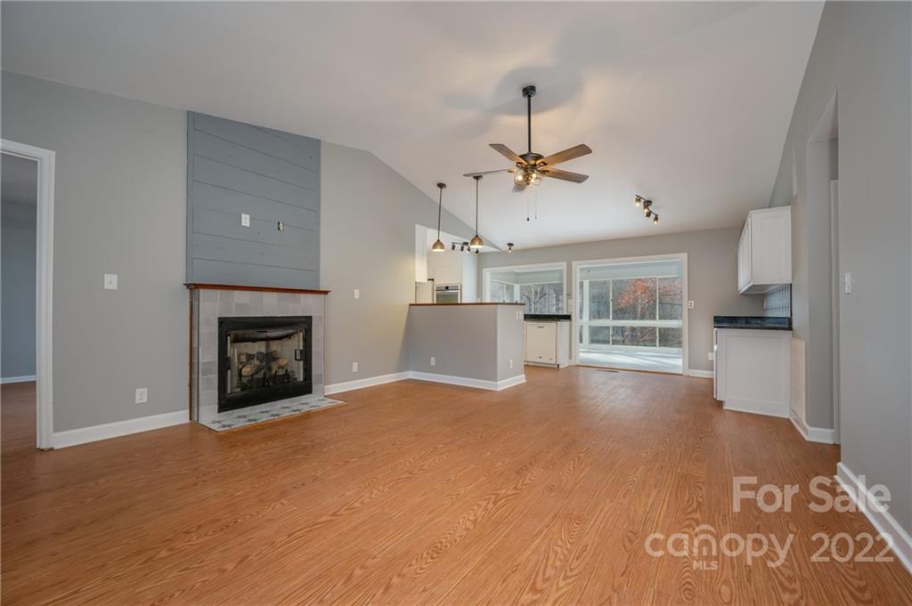 241 Hidden Hill Road Tryon, NC 28782 - Photo 3 of 39 a view of a livingroom with a fireplace and a kitchen