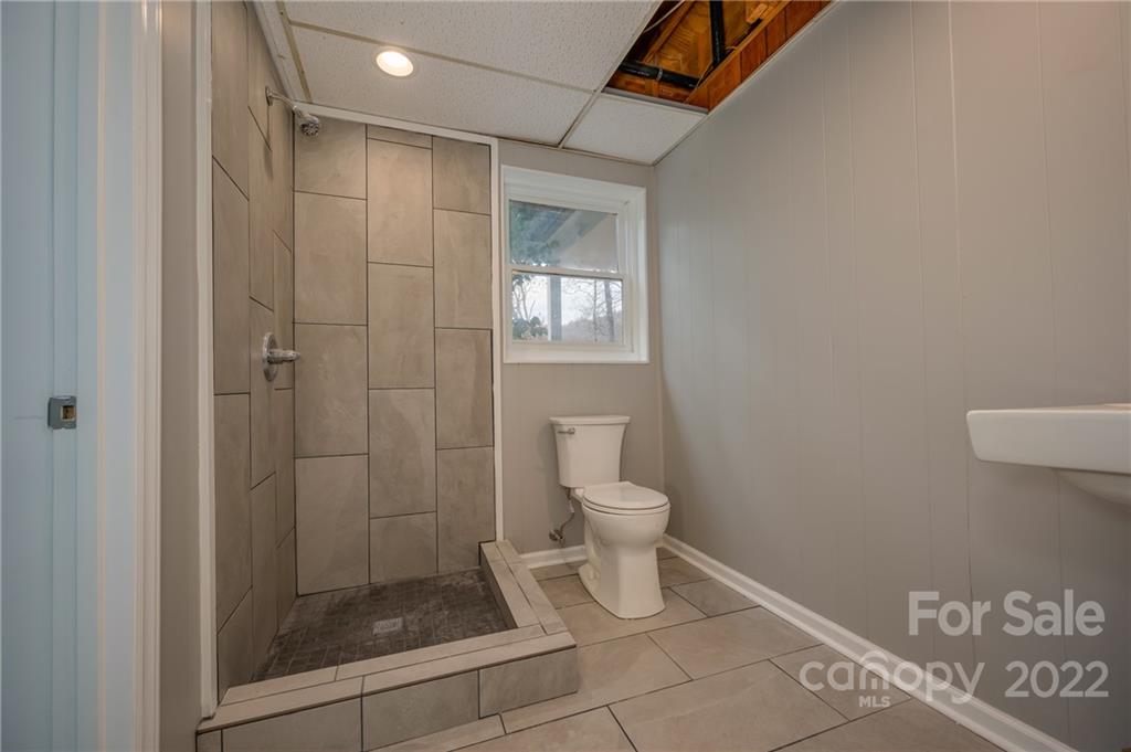 241 Hidden Hill Road Tryon, NC 28782 - Photo 31 of 39 a bathroom with a toilet and shower