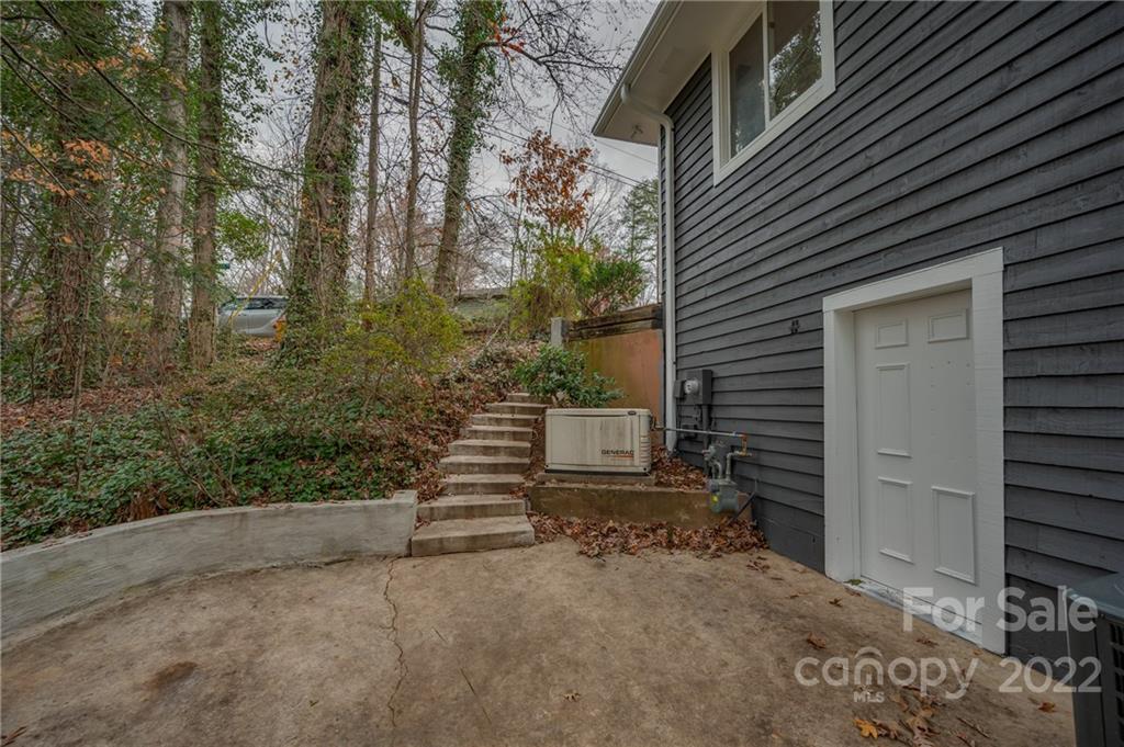 241 Hidden Hill Road Tryon, NC 28782 - Photo 37 of 39 a view of a house with backyard and garden