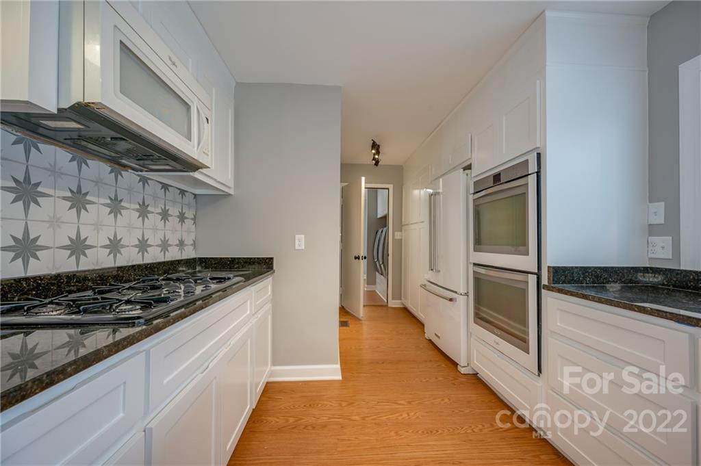 241 Hidden Hill Road Tryon, NC 28782 - Photo 4 of 39 a kitchen with stainless steel appliances granite countertop a stove and a refrigerator