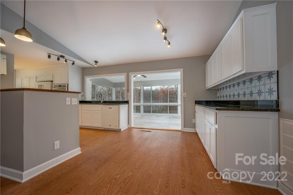 241 Hidden Hill Road Tryon, NC 28782 - Photo 8 of 39 a view of a kitchen with a sink and dishwasher wooden floor