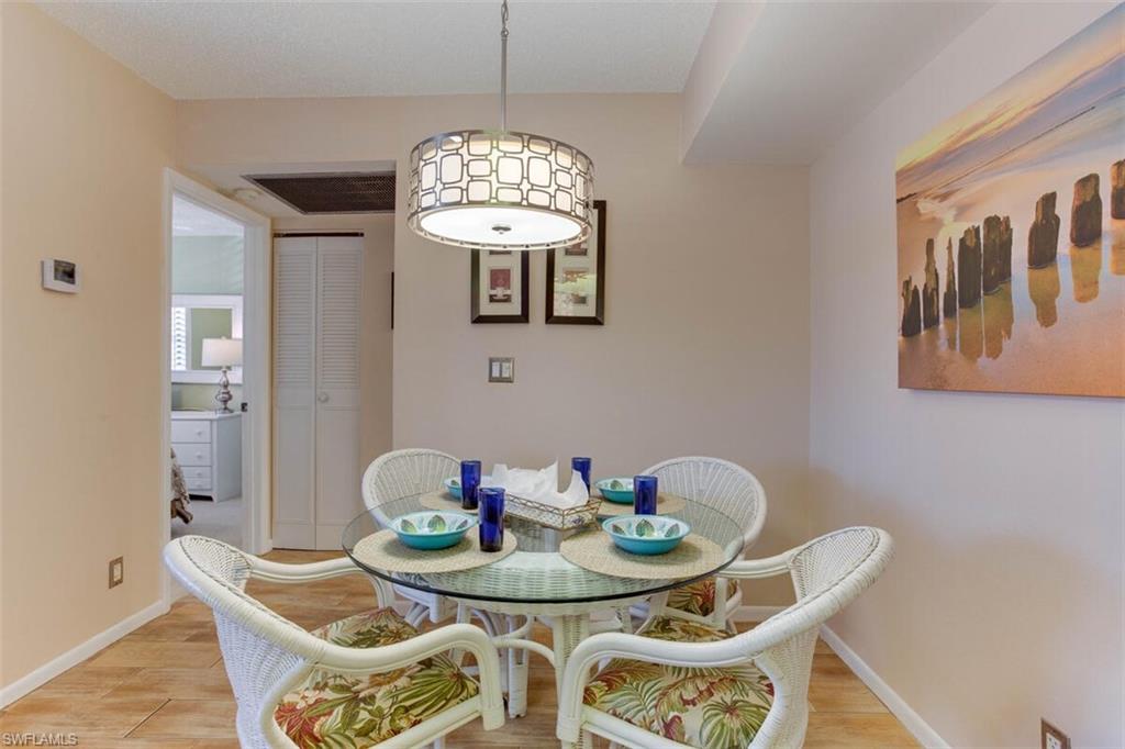 4345 27th Court Southwest, Unit 202 Naples, FL 34116 - Photo 11 of 26 a view of a dining room with furniture
