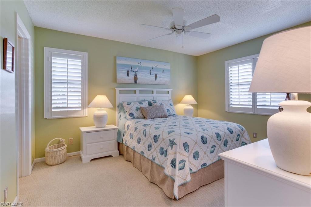 4345 27th Court Southwest, Unit 202 Naples, FL 34116 - Photo 14 of 26 a bedroom with bed and window