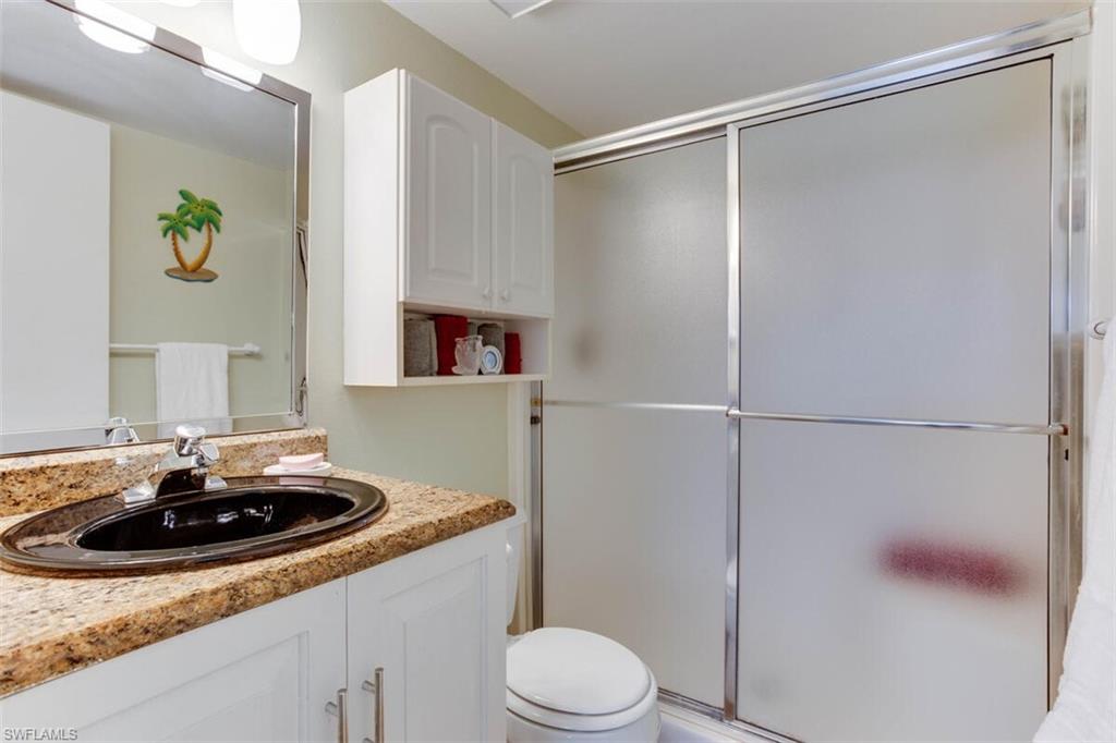 4345 27th Court Southwest, Unit 202 Naples, FL 34116 - Photo 19 of 26 a bathroom with a sink toilet and vanity