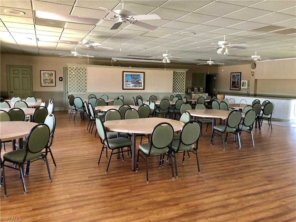 4345 27th Court Southwest, Unit 202 Naples, FL 34116 - Photo 26 of 26 a view of a dining room with furniture window and wooden floor