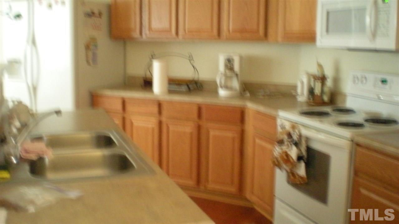 2516 Quarry Ridge Lane Raleigh, NC 27610 - Photo 5 of 10 a kitchen with a sink and cabinets