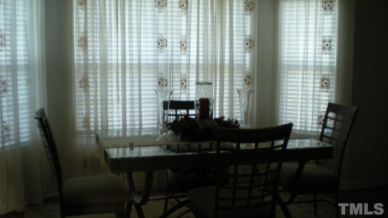 2516 Quarry Ridge Lane Raleigh, NC 27610 - Photo 6 of 10 a view of a dining room with furniture and wooden floor
