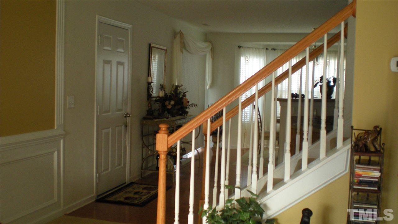 2516 Quarry Ridge Lane Raleigh, NC 27610 - Photo 8 of 10 a view of staircase with lots of frames on wall and stairs