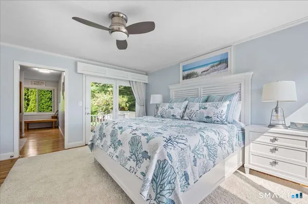 a bedroom with a large bed and a window