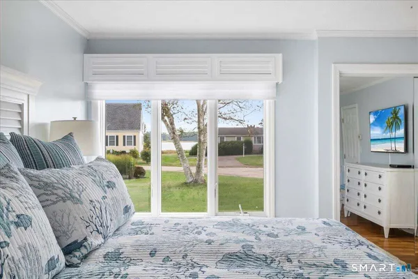 a living room with a large window and a wooden floor