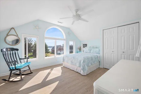 a bedroom with two beds and a chandelier