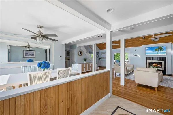 a living room with furniture a ceiling fan and a rug