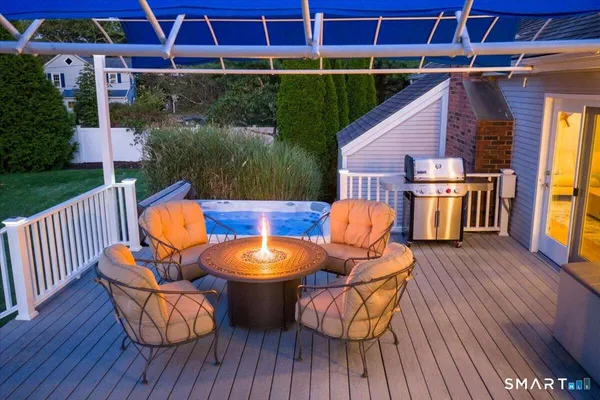 a view of a chairs and table in the roof deck