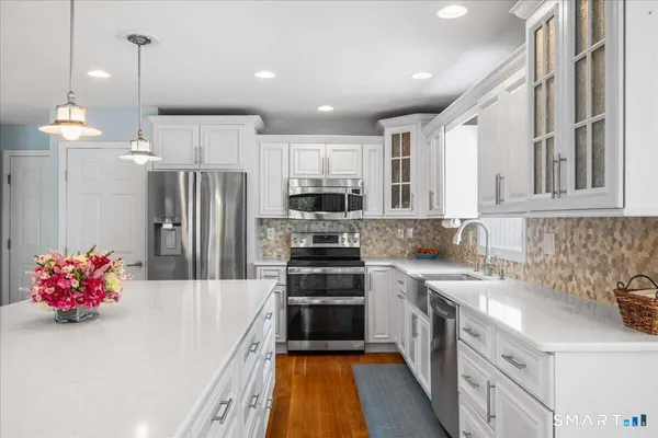 a kitchen with refrigerator a sink and cabinets