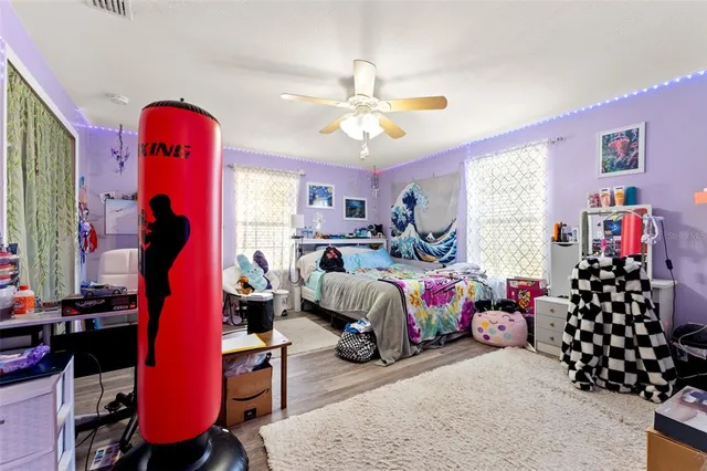 a living room with furniture a bookshelf and a window