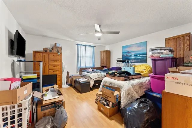 a bedroom with furniture and a wooden floor