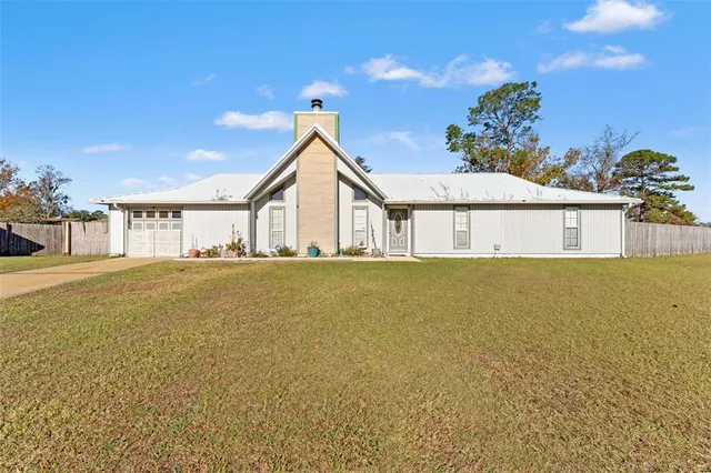 a house view with swimming pool in front of it