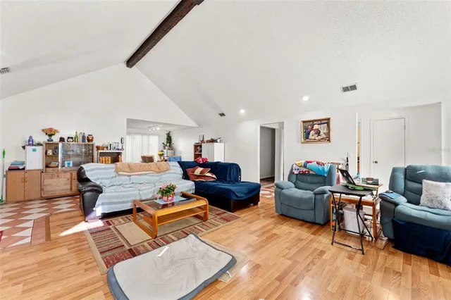 a living room with furniture and kitchen view