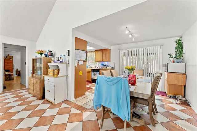 a living room with furniture a flat screen tv and a table