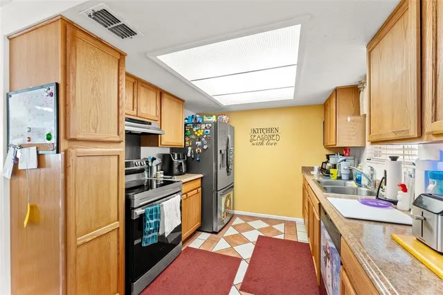 a kitchen with a sink stove and refrigerator