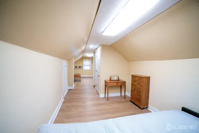 a view of a hallway with wooden floor and furniture