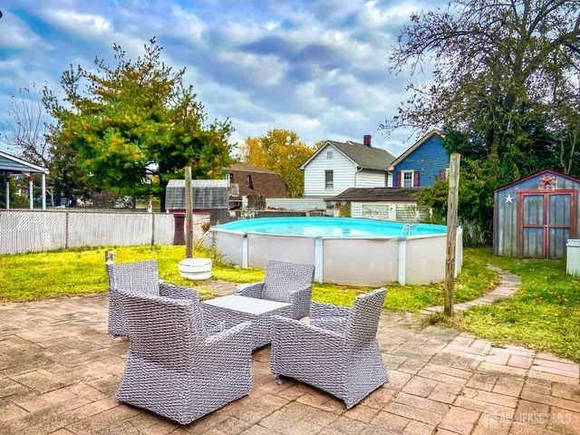 a view of a house with swimming pool and sitting area