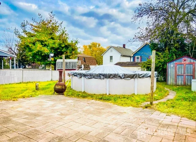 a swimming pool with yard and outdoor seating