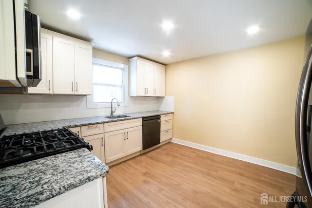 a kitchen with a stove a sink and a refrigerator