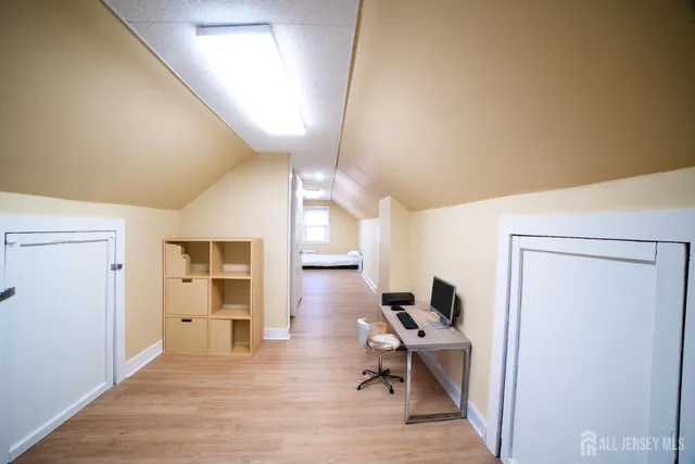 a workspace with wooden floor and a bathroom