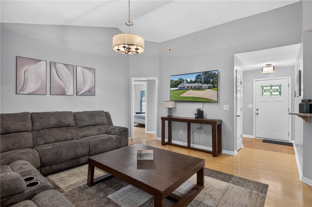 3336 Centerville Road Anderson, SC 29625 - Photo 6 of 50 A welcoming living area with vaulted ceilings and warm wood flooring creates an inviting atmosphere.