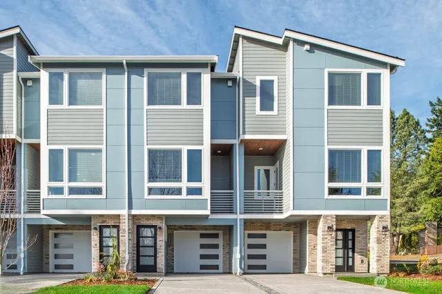 a front view of a residential apartment building with a yard