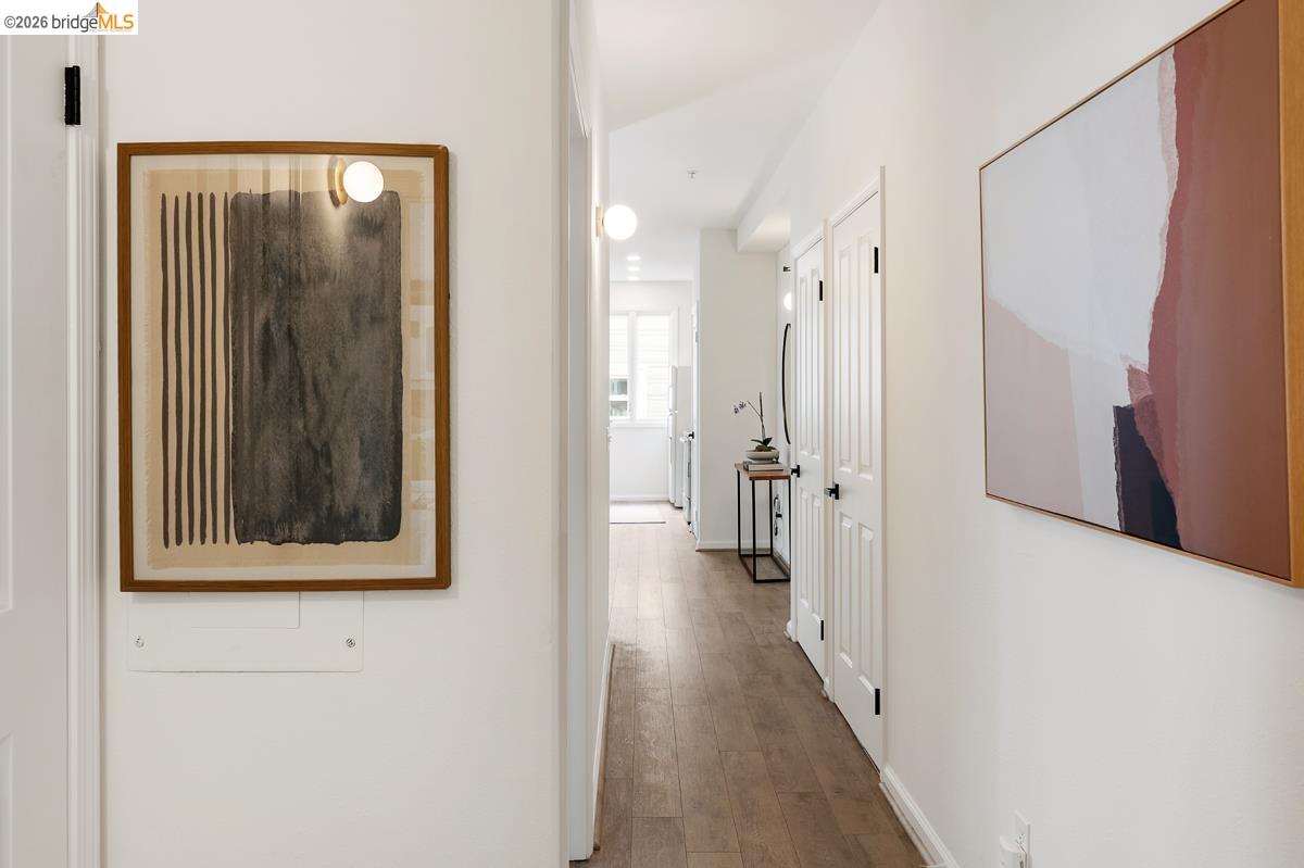 2029 Channing Way, Unit 3D Berkeley, CA 94704 - Photo 26 of 54 Hallway with wood-finish flooring and white walls