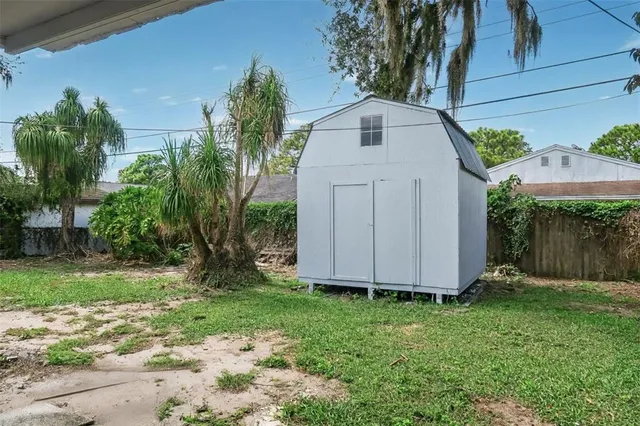 a white house with green field in front of it