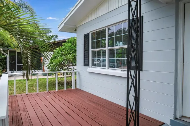 a view of a deck with a floor to ceiling window with wooden floor