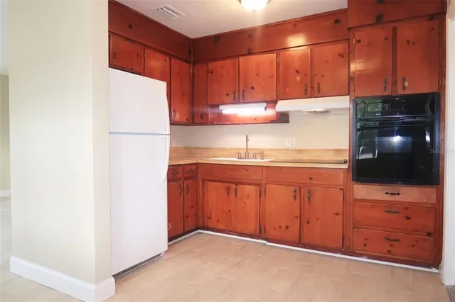 a kitchen with cabinets and appliances