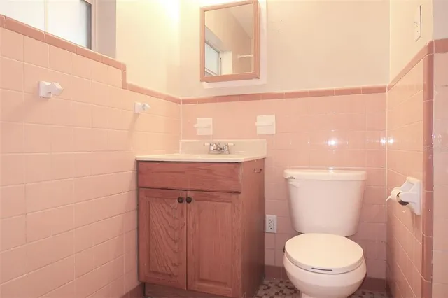 a bathroom with a sink a toilet and mirror