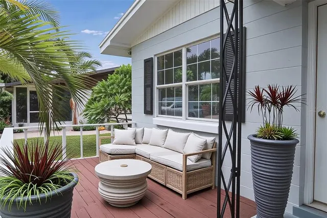a view of a porch with furniture and a potted plant