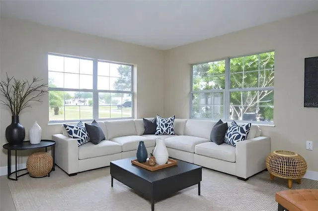 a living room with furniture and a large window