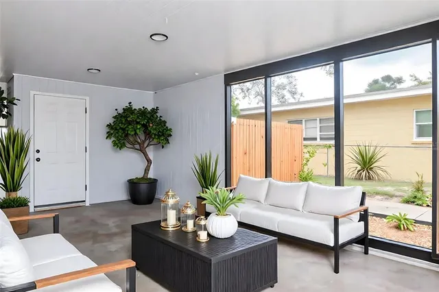 a living room with furniture and a potted plant