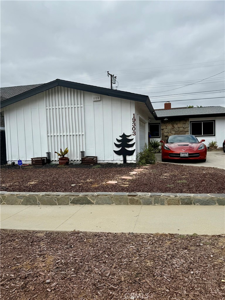 19303 Kemp Avenue Carson, CA 90746 - Photo 2 of 13 a front view of a house with a garden