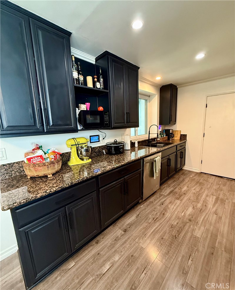 19303 Kemp Avenue Carson, CA 90746 - Photo 5 of 13 a kitchen with granite countertop a sink cabinets and stainless steel appliances