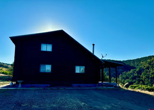 a view of house with yard