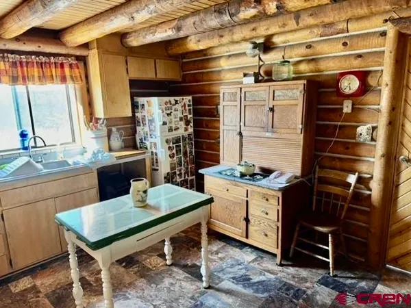 a dining room with furniture and a window