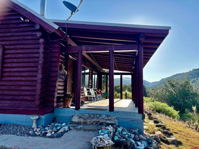 a view of porch with a table and chairs and potted plants