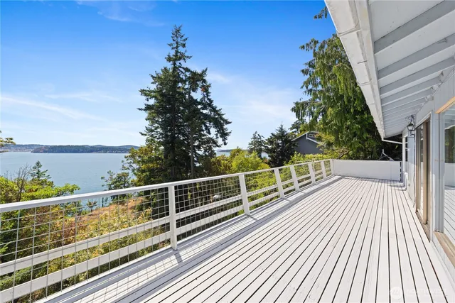 a view of balcony with wooden floor and fence
