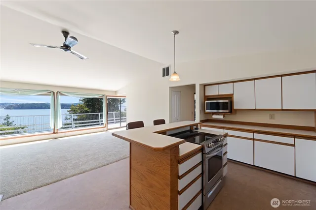 a kitchen that has a sink stove and cabinets